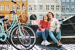 couple sitting next to bicycles