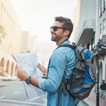 man looking at map while traveling