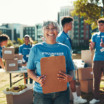 volunteer holding clip board and smiling