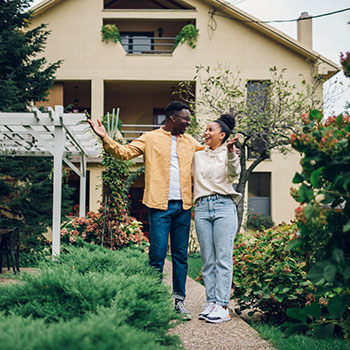 couple standing outside home