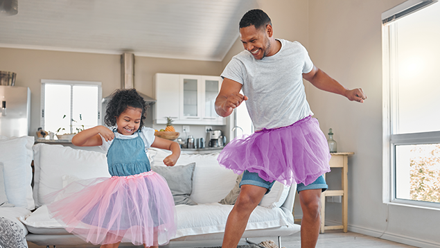 father and young daughter dancing in tutus