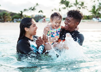 couple in pool with child