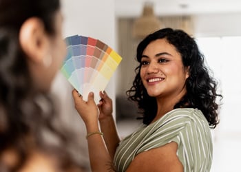 woman fanning color cards
