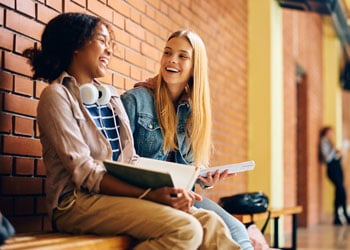 two female students laughing together