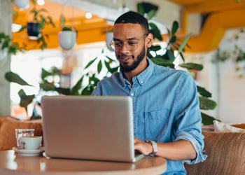 man at a laptop at a restaurant