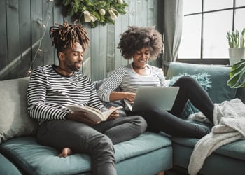 couple on sofa with their laptop
