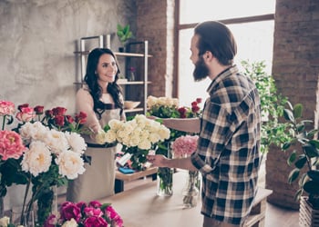 man in floral shop buying flowers