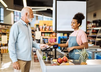 man checking out at the grocery store