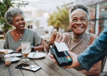 two women tapping to pay after lunch