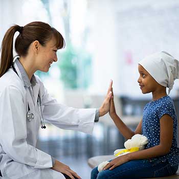 doctor high fiving young patient