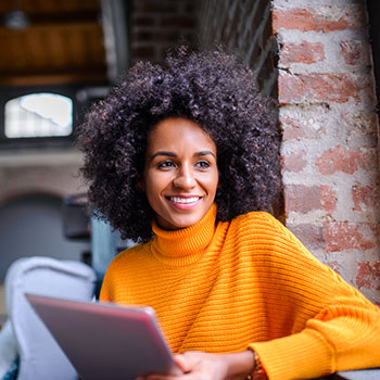 woman smiling with tablet in hand