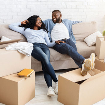 couple sitting on couch in new home