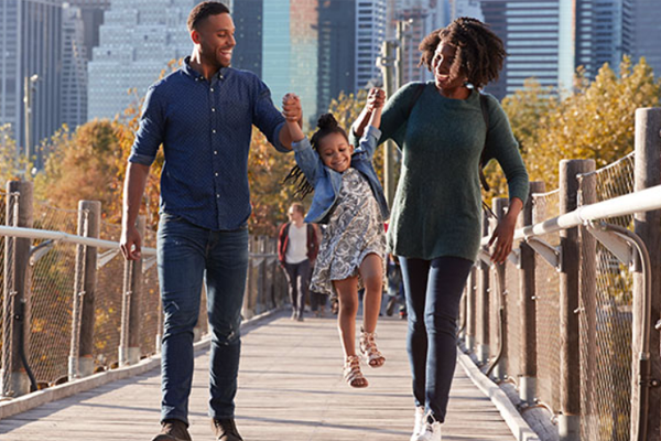 couple on bridge with child